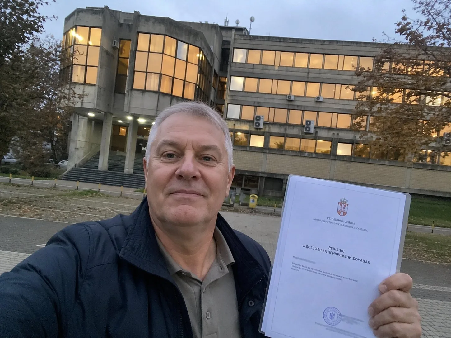 A client outside the police administration in Belgrade holding the decision granting temporary residence